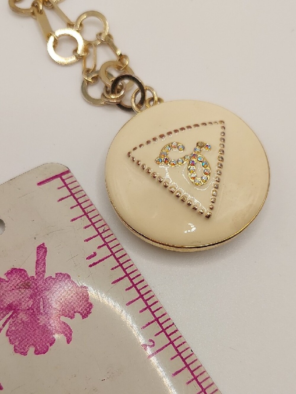 GUESS Blingy AB Gold-Tone Long Pendant Necklace with Cream Enamel Locket - Picture 8 of 14